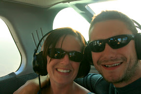 Our grinning faces in the back of the plane.