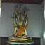 A huge golden Buddha, both touching the ground and being raised by a snake combining two stories from his history.