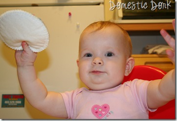 baby Lucy plays with nursing pad