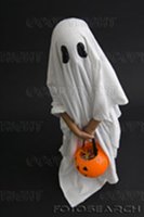 Kid wearing a bedsheet ghost costume