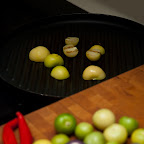 Tomatillos being charred for Salsa Verde