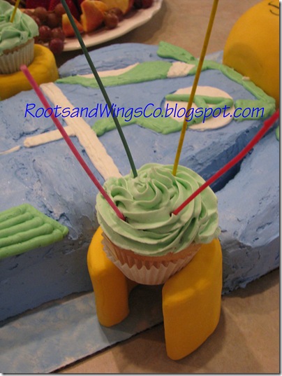Lego Agent cake holding cupcakes Lego Agent cake holding cupcakes