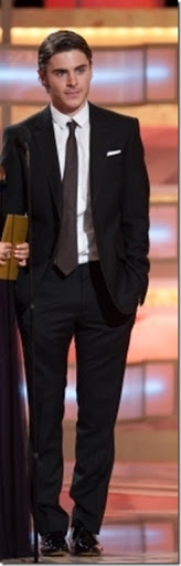 Zac Efron in a Burberry Suit and raising colored tie.