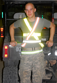 Sgt. Jason Guge of Billings, Mont., a Black hawk helicopter mechanic, wears several physical training belts in a hanger at Contingency Operating Base Adder, Iraq. Guge built a humorous web page dedicated to the belts which has 1,000 followers and counting.