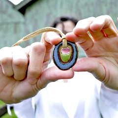 eclectic geometric stoneware hippie pendant model shot by glazedOver Pottery blue with green center eclectic geometric stoneware hippie pendant model shot by glazedOver Pottery blue with green center