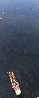 Support ships sit in oily water at the site of the Deepwater Horizon oil spill in the Gulf of Mexico off the coast of Louisiana Wednesday, May 12, 2010. (AP Photo / Charlie Riedel)