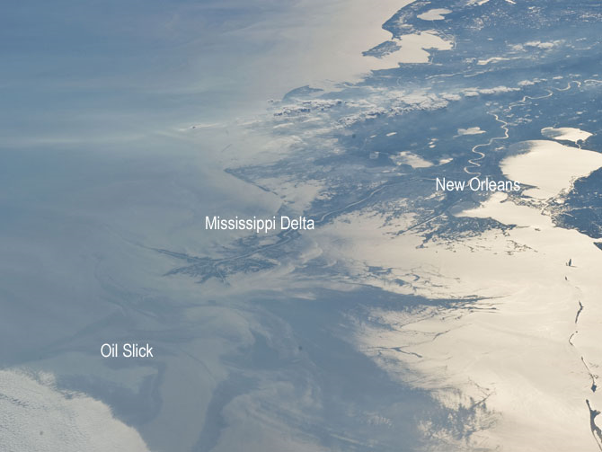 Japan Aerospace Exploration Agency (JAXA) astronaut Soichi Noguchi, Expedition 23 flight engineer, photographed the tail end of the Mississippi Delta showing the oil slick in the Gulf of Mexico on May 4, 2010. Part of the river delta and nearby Louisiana coast appear dark in the sunglint. The sunglint improves the identification of the oil spill which is creating a different water texture (and therefore a contrast) between the smooth and rougher water of the reflective ocean surface. Credit: NASA
