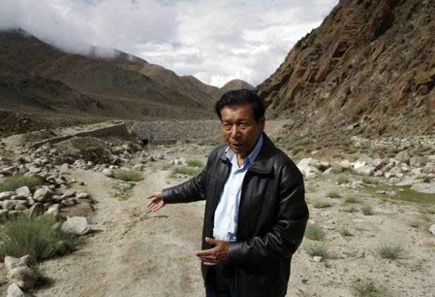 Chewang Norphel at the site of an empty reservoir in Ladakh, India. GETTY IMAGES