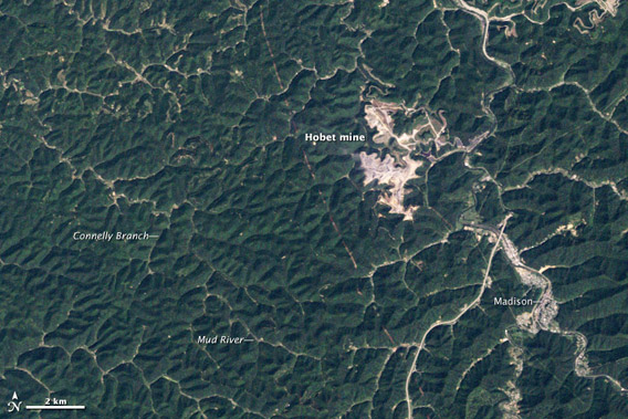 Mountaintop removal in Boone County, West Virginia. The images show forests being stripped, valleys filled, and giant craters excavated in the process of mining thin seams of coal at Hobet mine. NASA Earth Observatory