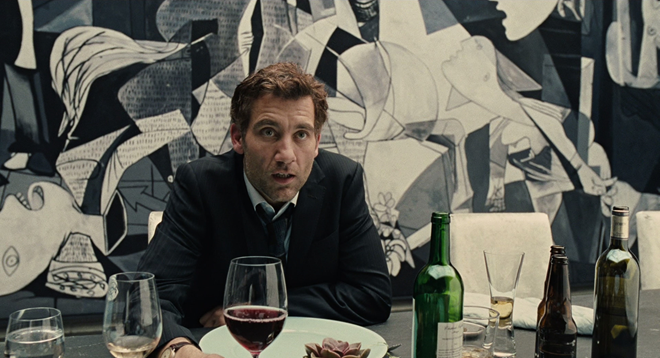 Screenshot from “Children of Men” showing Clive Owen dining beneath “Guernica”. (dir. Alfonso Cuarón, 2006). Graphic: Universal Studios