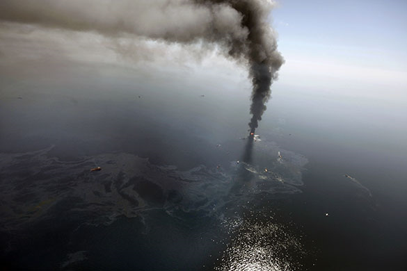 An oil slick spreads as the Deepwater Horizon burns. Photograph: Gerald Herbert / AP