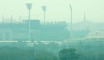 Hard to see ... the MCG is blanketed in a thick smoke haze yesterday. Picture: Bruce Long 