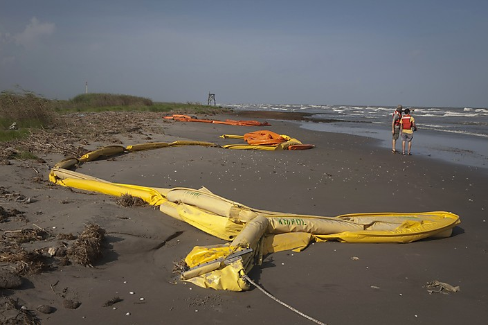 A piece of boom used as protection against oil drifting toward land sits on a beach as members of the environmental group Greenpeace look for signs of oil in Southwest Pass, Louisiana. Lee Celano / Reuters
