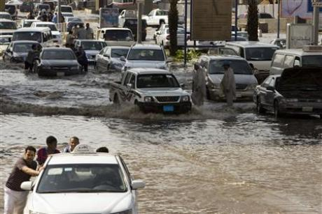 Men push their cars through flooded streets after a storm produced heavy rain in Jeddah November 25, 2009. Credit: REUTERS / Caren Firouz