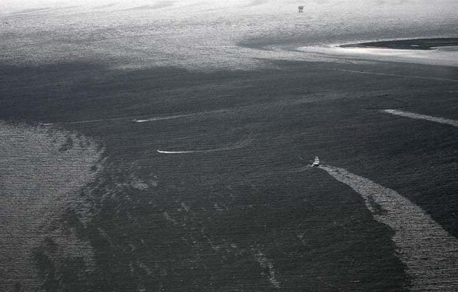 Boats leave a trail through the oil coating the water's surface and inundating Barataria Bay through passes between Louisiana's barrier islands just east of Grand Isle, La., even as oil continues to spew from the Deepwater Horizon spill into the Gulf of Mexico, Wednesday, June 2, 2010. PHOTO BY TED JACKSON / THE TIMES-PICAYUNE