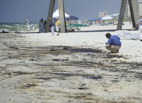 Heavy oil tar balls, mats and mousse showed up along the shoreline at Pensacola Beach early Wednesday morning, 23 June 2010. Gov. Charlie Crist, in town for a tour of the beach and cleanup, examined the heavy oil on Casino Beach near the beach fishing pier late this morning. Katie King / kking@pnj.com