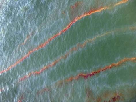 Wide streaks of red, brown and oragne crude oil stretch across the surface of the Gulf within three miles of the Perdido Pass on Thursday morning, 24 June 2010. Katie King / kking@pnj.com