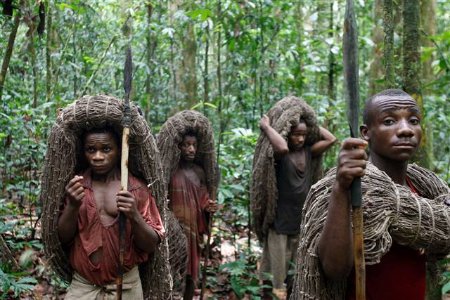 Mbuti pygmy men, from left, Faizi Malambi, Kawaya Situka, Besei and Kange Ambali carry hunting nets and spears as they await the start of the day's hunt in the Okapi Wildlife Reserve outside the town of Epulu, Congo, on March 18. The pygmies' traditional practice of hunting bushmeat has devolved into an all-out commercial endeavor, staged not for subsistence, but to feed growing regional markets. The result: the forests that remain are growing emptier by the day. Rebecca Blackwell / AP