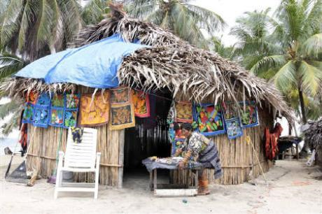 A Kuna lady prepares her Molas (crafts) on Neddle island in Kuna Yala June 5, 2010. Rising seas from global warming, coming after years of coral reef destruction, are forcing thousands of indigenous Panamanians to leave their ancestral homes on low-lying Caribbean islands. Credit: Reuters / Alberto Lowe / Files