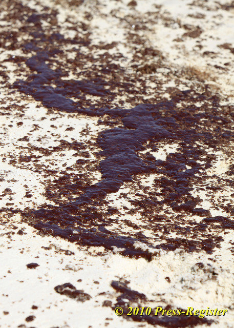 Oil is seen at the edge of the surf in Gulf Shores, Alabama, in this photograph from Thursday, June 24, 2010. Press-Register / John David Mercer