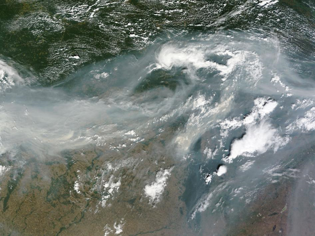 Smoke over Western Russia. Hundreds of fires burned across western Russia on August 2, 2010, but it is the smoke that conveys the magnitude of the disaster in this true-color image from the Moderate Resolution Imaging Spectroradiometer (MODIS) on NASA&rsquo;s Terra satellite. Dense gray-brown smoke extends across the width of this image, a distance of about 1,700 kilometers (1,000 miles). The smoke clearly continues both east and west beyond the edge of the image. NASA / MODIS Rapid Response