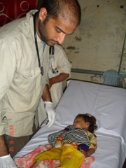 Iqra being tended by Dr Saqib Noor. &copy;Doctors Worldwide