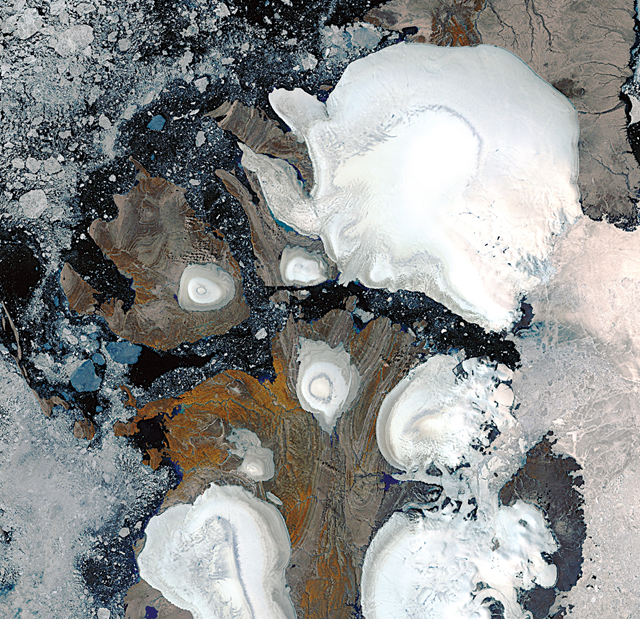 Landsat image of ice caps in northern Savernaya Zemlya, Russian Arctic Islands (80 degrees N.). The scene shows zones of melting  on the ice caps. The largest ice cap is about 80 km across.  Image courtesy of Julian Dowdeswell, Scott Polar Research Institute, Cambridge, UK.