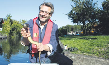 Jon Henley gets to grips with an eel at Molesey Lock on the Thames. Eel populations are Photograph: Sally Catmull for the Guardian