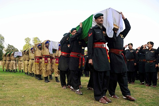 Pakistani soldiers carry coffins of their colleagues during a funeral. Agence France-Presse