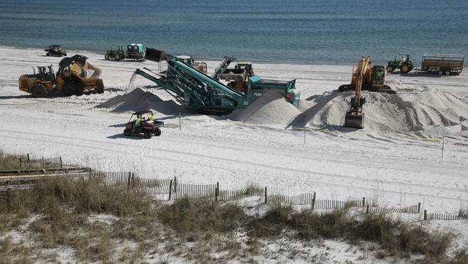 In this photo taken Tuesday, Nov. 9, 2010, BP operates a deep sand cleaning operation in Orange Beach, Ala. The oil company has launched its biggest push yet to deep-clean the tourist beaches that were coated with crude during the worst of the Gulf oil spill. Machines are digging down into the sand to remove buried tar mats left from the Deepwater Horizon disaster. AP Photo / Dave Martin