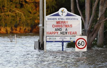 Signboards are partially submerged by floodwater in Bundaberg, Queensland December 31, 2010. Reuters / Daniel Munoz