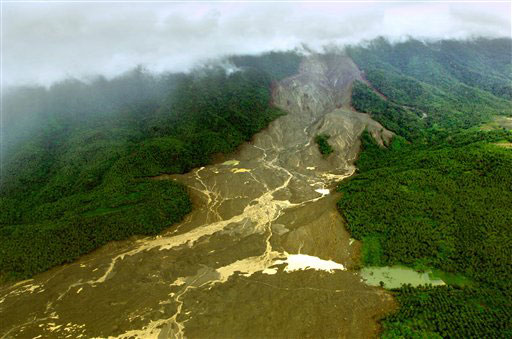 An aerial view Thursday, Feb. 23, 2006, of the landslide covering Guinsaugon village on the island of Leyte in the Philippines. Rescue efforts were suspended Thursday due to heavy rain and unsafe conditions after a group of seven Taiwanese disaster experts were rescued by U.S. Marines. Most of the population of Guinsaugon was feared buried alive when a rain-soaked mountain collapsed. cbsnews.com / AP Photo / Lucy Pemoni