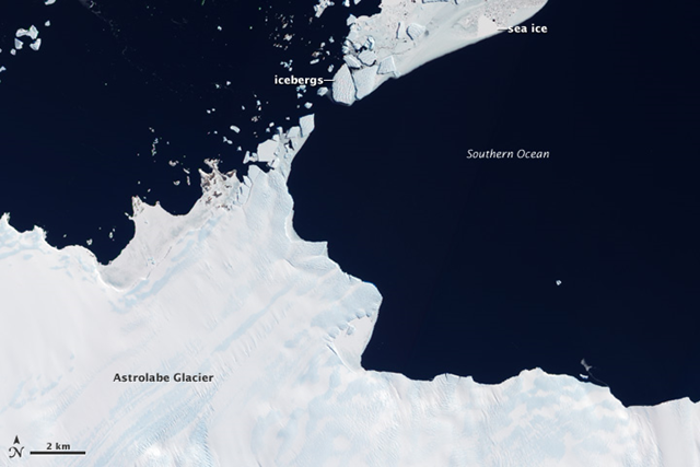 Located in the Terre Ad&eacute;lie-George V Land section of East Antarctica, Astrolabe Glacier streams out from the interior of Antarctica to dump ice into the sea, November 28, 2010. This outlet glacier is estimated to be 10 kilometers (6 miles) wide, and the drainage basin that feeds it stretches as much as 200 kilometers (120 miles) inland. NASA Earth Observatory image by Jesse Allen and Robert Simmon, using ALI data from the EO-1 Team