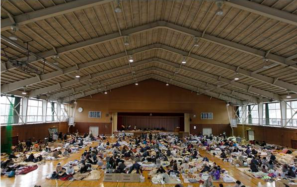 Evacuees, who fled from the vicinity of Fukushima nuclear power plant, rest at an evacuation center set in a gymnasium in Kawamata, Fukushima Prefecture in northern Japan, 15 March 2011. Reuters
