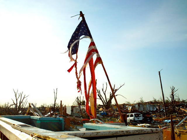 A shredded American flag stands in the wreckage of a church in Joplin, Missouri, 24 May 2011. AP / telegraph.co.uk