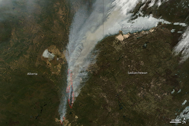The Moderate Resolution Imaging Spectroradiometer (MODIS) on NASA&rsquo;s Terra satellite took this image at 12:35 p.m. local time on May 16, 2011. Similar images of central Canada are available twice daily. The image provides a view of a massive fire burning south of Lake Athabasca. Fire detections are outlined in red. Strong winds fanned the fires on May 15 and 16, pulling thick plumes of smoke north. NASA images courtesy the MODIS Rapid Response Team at NASA GSFC