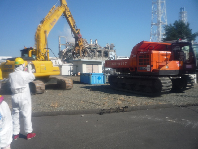 Workers at the Fukushima Daiichi nuclear plant use heavy equipment to clear radioactive debris. TEPCO