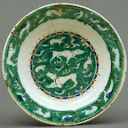 The animals on this dish, some more recognizable than others, may derive from representations on Seljuq metalwork. The central design is, in effect, a painted menagerie, an approach not often attempted by Iznik potters before around 1570. Another group of animals pursue one another on the rim of the dish. The bold effect of the bright green ground is heightened by the potter's decision to leave the cavetto blank, in essence providing breathing room for the composition. Source: Dish [Iznik, Turkey] (1979.412) | Heilbrunn Timeline of Art History | The Metropolitan Museum of Art