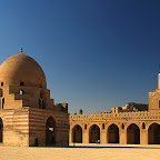 The Ibn Tulun Mosque was completed in 879 AD by the founder of Egypt's Tulunid Dynasty, Ahmad Ibn Tulun. It is one of the oldest mosques in Cairo and is now a popular tourist attraction. The inner arcades present a frieze of floral decoration that runs around the arches, and above the arches Kufic inscriptions of the Qur'an are said to run some two kilometers. Interestingly, folktales maintain that this frieze was believed to have been carved onto the planks from Noah's Ark. Perhaps the most impressive feature is its simplicity in design, whilst at the same time being extravagantly decorated. Flickr Explore July 16, 2009 - highest position #138.Mosque of Ibn Tulun :: © Julian Kaesler ::