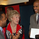 Kwame laughs with Chairman Sheila Stampfli and WCSA President and CEO Greg O'Dell