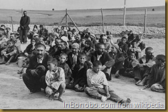 Romani arrivals in the Belzec extermination camp await instructions