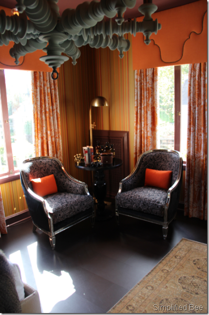 orange wallpaper bedroom seating area