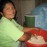 Beneranda Hernández, one of the mothers, helps out by making dough for tortillas