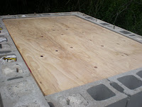 The form that supports the concrete from inside the block stand, before being shimmed to level with the top of the concrete blocks.