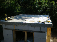 The hearth-supporting slab covered in tools and ready to go.