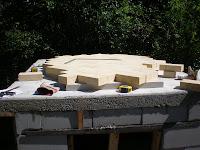 Insulation board cut to fit and floor bricks dry-laid and ready to be cut to size.