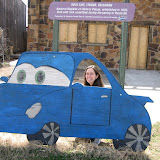Katie having fun with a car cutout along the road in Stroud, Oklahoma