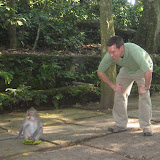 Dan watches as a monkey eats some bananas