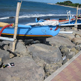 Local fishing boats resting on the rocks above the ocean.  This one even has some personality!
