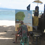 A local artist spends the afternoon painting a beach scene.
